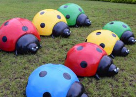 公園里擺放的一群玻璃鋼彩繪七星瓢蟲雕塑